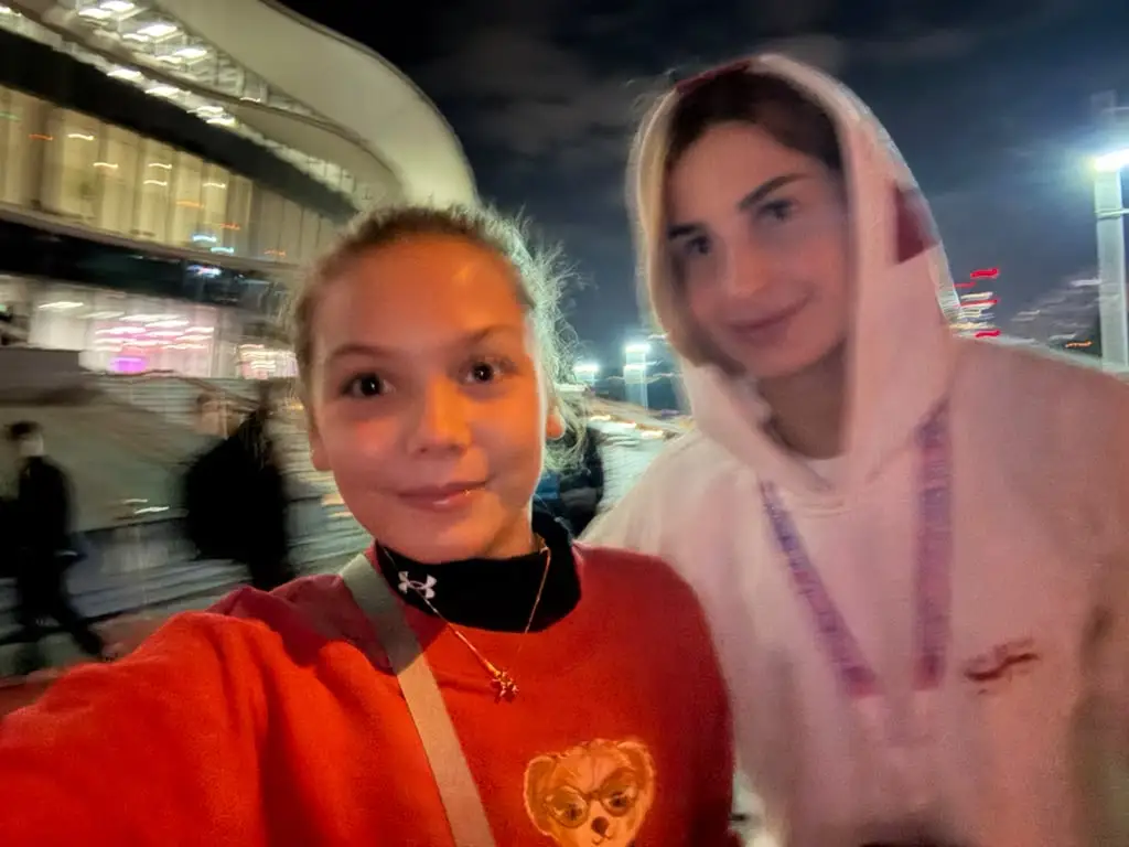 Melissa and a girl in a hoodie in a night-time selfie