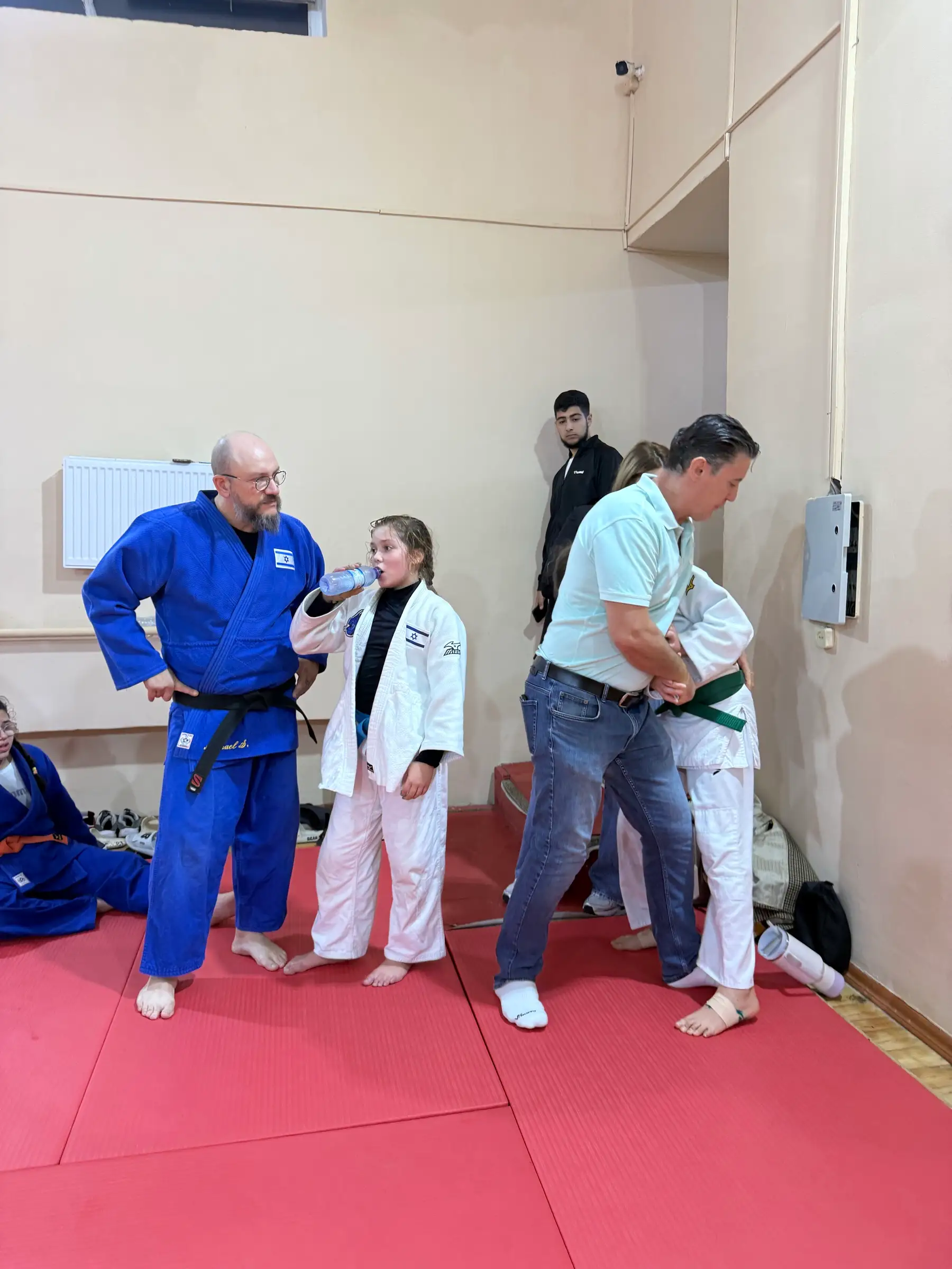 Melissa and other people in a crowded corner of the training hall